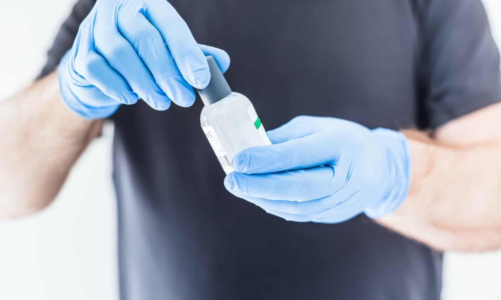 Hand sanitizer hygiene alcohol gel bottle in hands